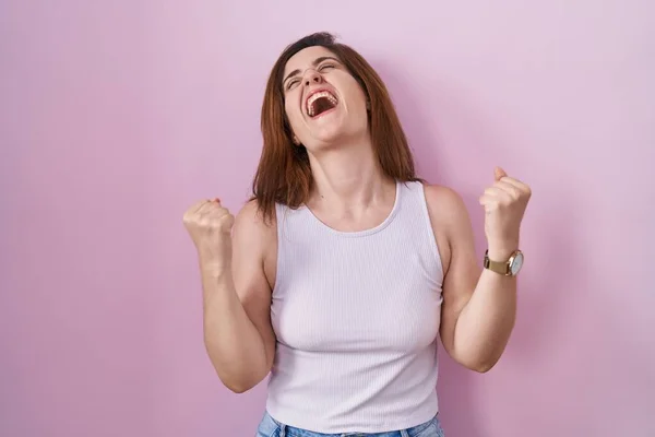 Brunette Woman Standing Pink Background Celebrating Surprised Amazed Success Arms — Stock Photo, Image
