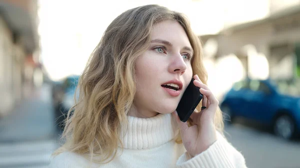 Young Blonde Woman Talking Smartphone Relaxed Expression Street — Stockfoto