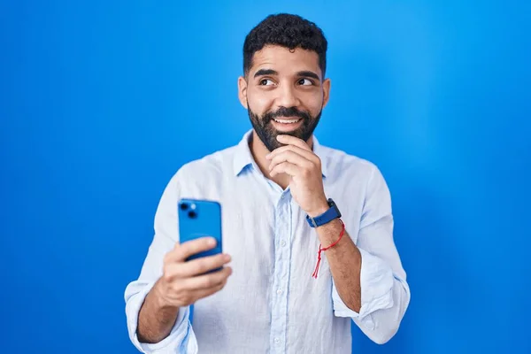 Hispanic Man Beard Using Smartphone Typing Message Hand Chin Thinking — Stock Photo, Image