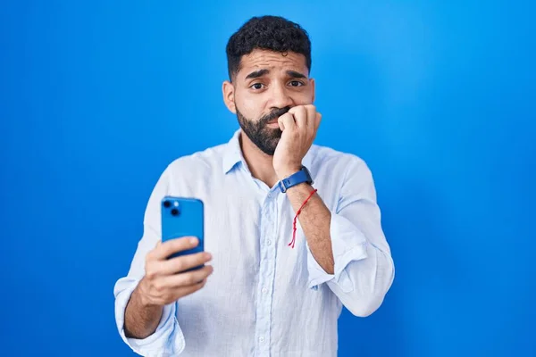 Latynos Brodą Pomocą Smartfona Wpisując Wiadomość Wyglądając Zestresowanego Nerwowego Rękami — Zdjęcie stockowe