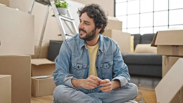 Young Hispanic Man Smiling Confident Sitting Floor New Home — Stockfoto