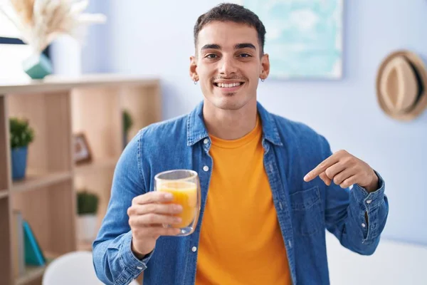 Handsome Hispanic Man Drinking Glass Orange Juice Pointing Finger One — Stock Photo, Image