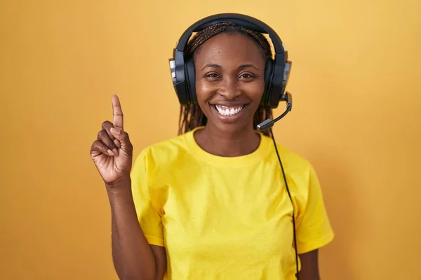 Afrikai Amerikai Zenét Hallgat Fülhallgatóval Mutatja Rámutatva Első Számú Ujjával — Stock Fotó