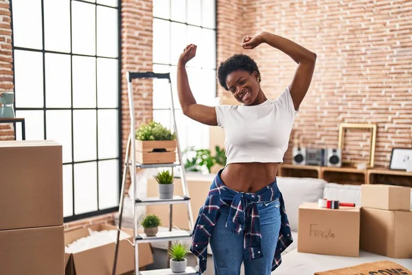 African American Woman Smiling Confident Stretching Arms New Home — стоковое фото