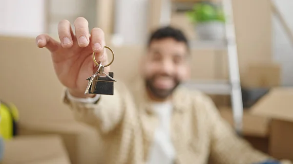 Young Hispanic Man Holding Keys Sitting Floor New Home — Stock Photo, Image