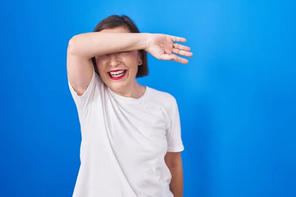 Middle Age Hispanic Woman Standing Blue Background Covering Eyes Arm — 图库照片