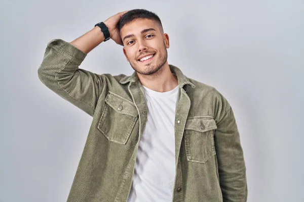 Young Hispanic Man Standing Isolated Background Smiling Confident Touching Hair — Stock fotografie