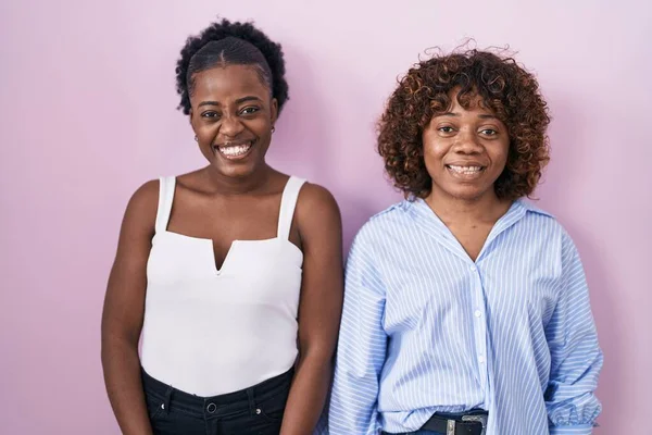 Two African Women Standing Pink Background Winking Looking Camera Sexy — Photo