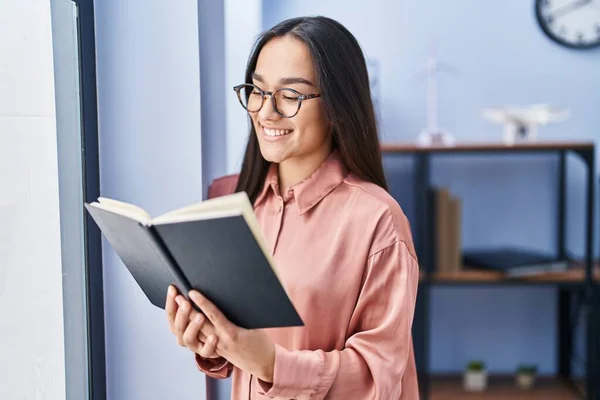 stock image Young hispanic woman business worker reading book at office