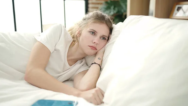 Young Blonde Woman Lying Bed Sad Expression Bedroom — стоковое фото