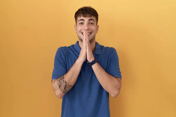 Young Hispanic Man Standing Yellow Background Praying Hands Together Asking — 스톡 사진