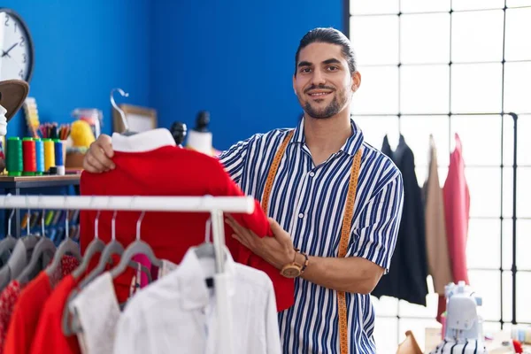 Young Hispanic Man Tailor Smiling Confident Holding Shirt Rack Sewing — Foto de Stock
