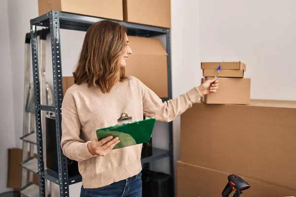 stock image Young woman ecommerce business worker writing on clipboard at office