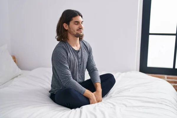 Young Hispanic Man Sitting Bed Meditating Bedroom — Stok fotoğraf