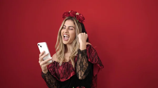 Young Blonde Woman Using Smartphone Having Halloween Party Isolated Red — Fotografia de Stock