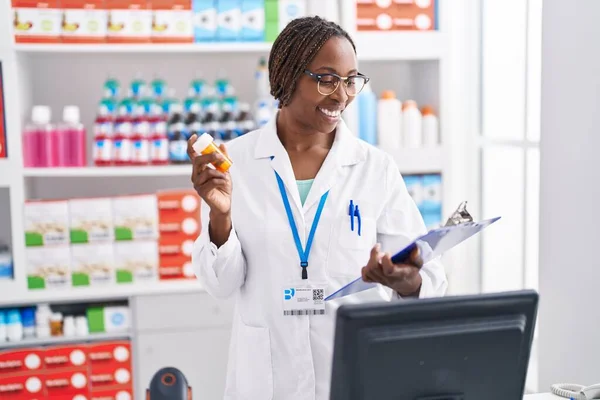 Afrikaans Amerikaanse Vrouw Apotheker Holding Pillen Fles Lezen Document Bij — Stockfoto