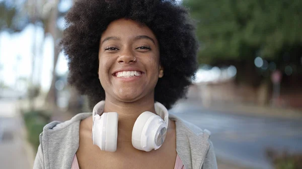 stock image African american woman smiling confident wearing headphones at street