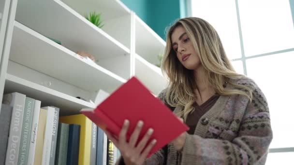 Young Blonde Woman Student Reading Book Standing Library University — Stockvideo