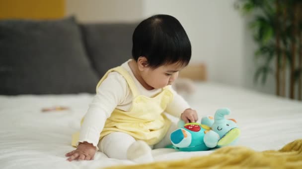 Adorable Hispanic Baby Playing Elephant Doll Sitting Bed Bedroom — Wideo stockowe