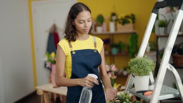 Young African American Woman Florist Using Diffuser Watering Plant Flower — Stock video