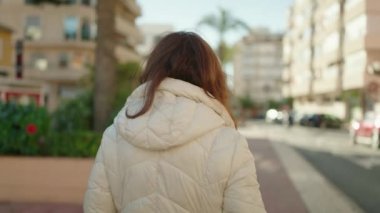 Middle age redhead woman smiling confident walking at street