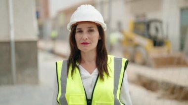 Young beautiful hispanic woman architect smiling confident standing at street