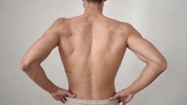 Young hispanic man suffering for backache over isolated white background