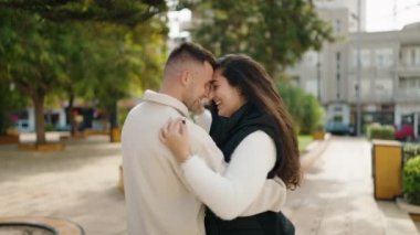 Young couple smiling confident dancing at park