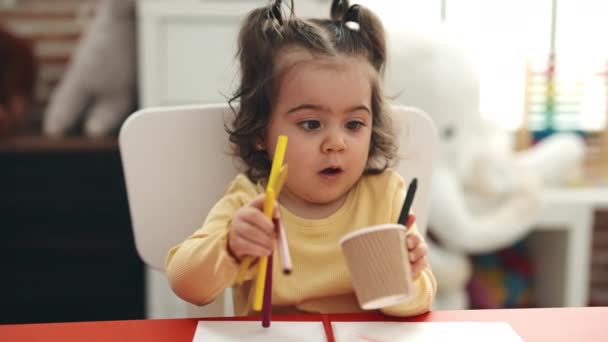 Adorable Hispanic Girl Student Sitting Table Putting Pencil Color Cup — Stockvideo
