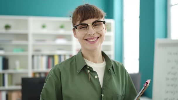 Young Caucasian Woman Smiling Wearing Glasses Holding Clipboard Library University — Vídeo de stock