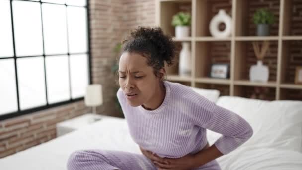 African American Woman Suffering Menstrual Pain Sitting Bed Bedroom — стокове відео