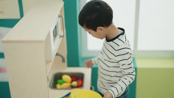 Adorable Hispanic Boy Playing Play Kitchen Standing Kindergarten — Video