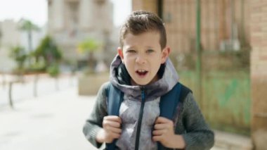Blond child student screaming at street