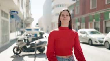 Young woman smiling confident standing with arms crossed gesture at street