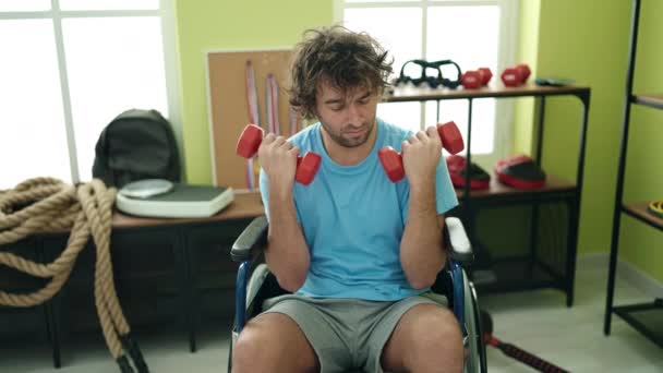 Young Hispanic Man Sitting Wheelchair Training Dumbbells Rehab Clinic — Video