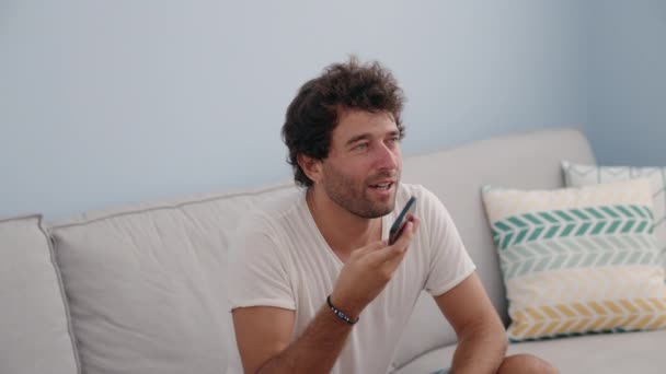 Young Hispanic Man Talking Smartphone Sitting Sofa Home — Stock videók