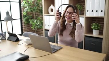 Young beautiful hispanic woman call center agent smiling confident working at office