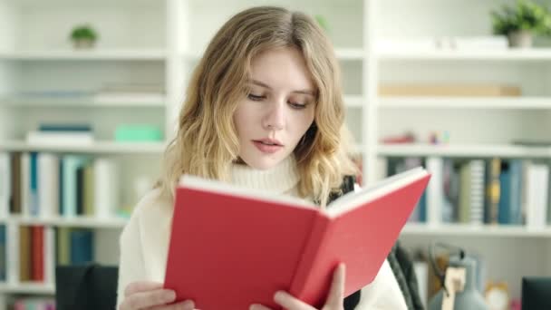 Young Blonde Woman Student Smiling Confident Reading Book Library University — 图库视频影像