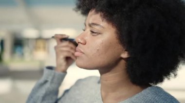 African american woman smiling confident listening audio message by the smartphone at park