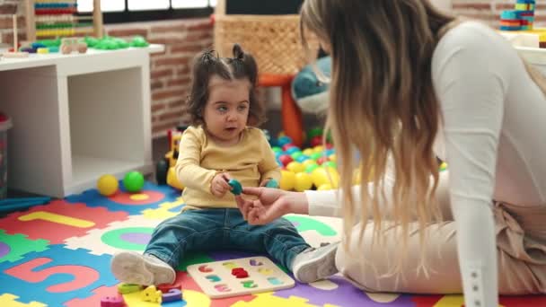 Teacher Toddler Playing Maths Puzzle Game Sitting Floor Kindergarten — Vídeos de Stock