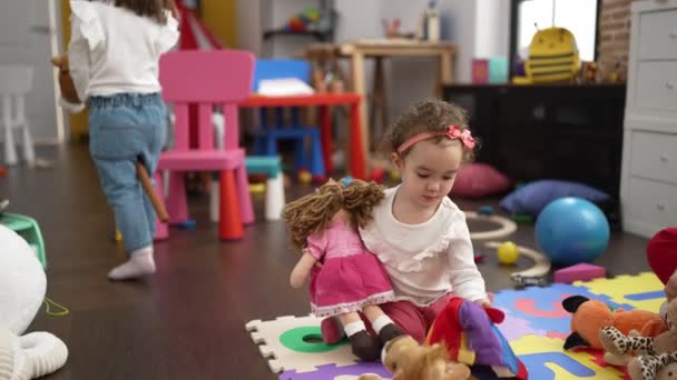 幼稚园的老师和幼儿与玩具娃娃一起坐在地板上玩耍 — 图库视频影像