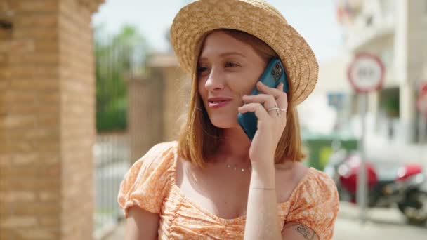 Young Redhead Woman Tourist Wearing Summer Hat Talking Smartphone Street — Vídeos de Stock