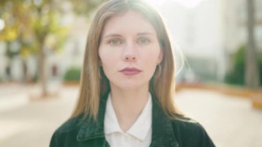 Young caucasian woman smiling confident standing with arms crossed gesture at park