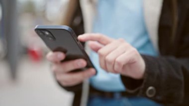 Sokakta akıllı telefon kullanan güzel bir İspanyol kadın.