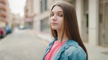 Adorable girl smiling confident looking to the camera at street