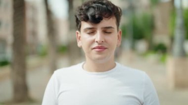 Non binary man smiling confident standing at park