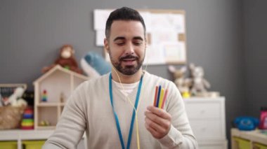 Young hispanic man on a video call working as teacher at kindergarten