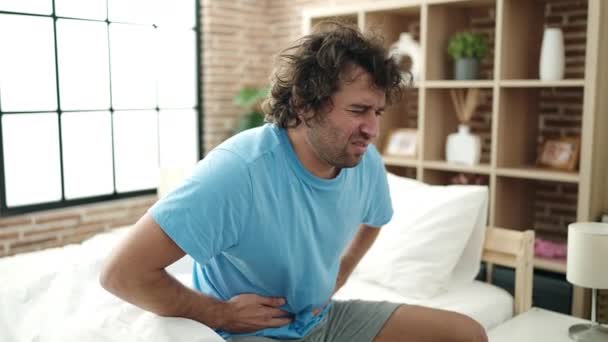 Young Hispanic Man Suffering Stomach Ache Sitting Bed Bedroom — Video Stock