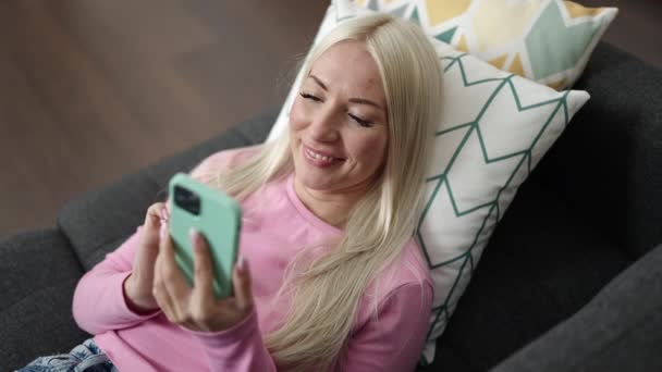 Mladá Blondýna Žena Pomocí Smartphone Ležící Pohovce Doma — Stock video