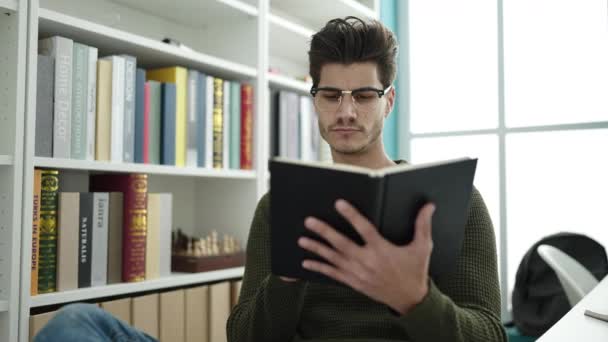 Young Hispanic Man Student Reading Book Studying Library University — Stockvideo